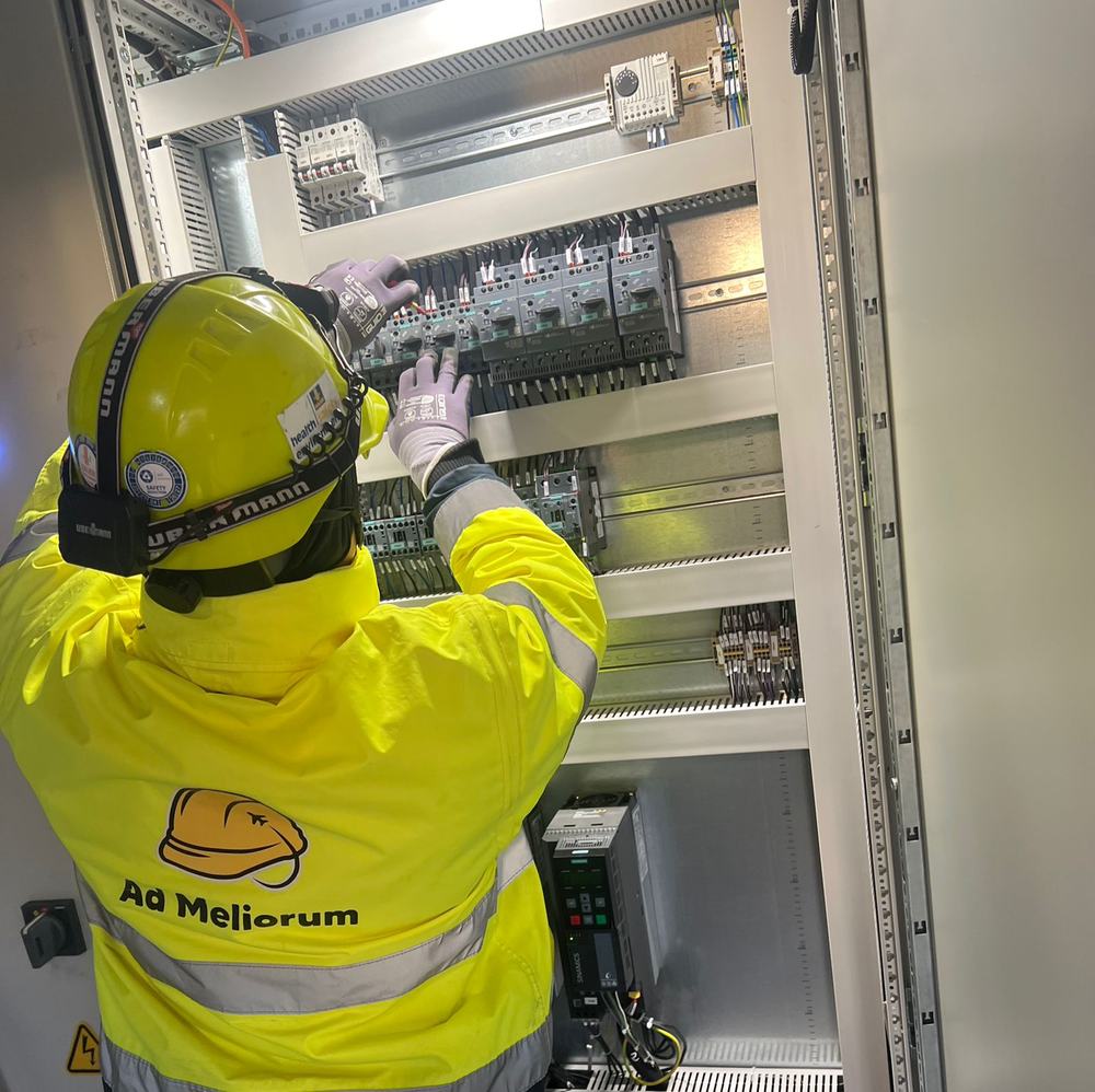 An Ad Meliorum electrician wiring a control cabinet